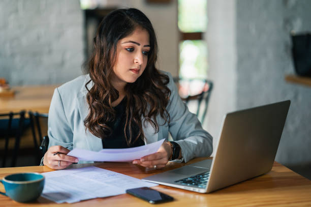 istock Businesswoman working on laptop and writing important notes. 1366254279