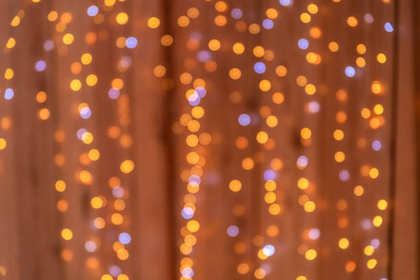istock light from garlands on a brown background. holiday, christmas, new year 1366255254