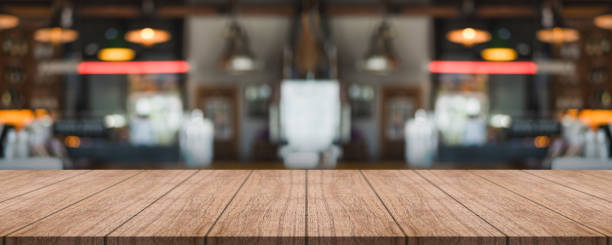 istock Empty wooden table top with lights bokeh on blur restaurant background. 1366256976