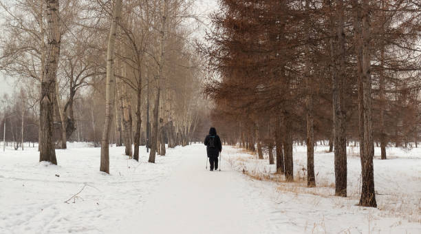 istock Woman walking in winter park 1366257048