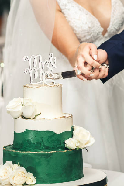 istock newlyweds cut wedding white-green cake 1366259644
