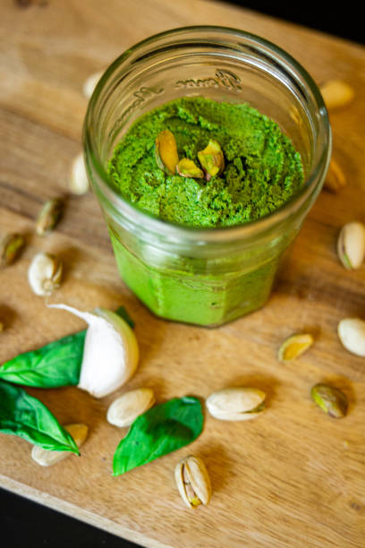 istock pistachio pesto glass jar green paste 1366259846