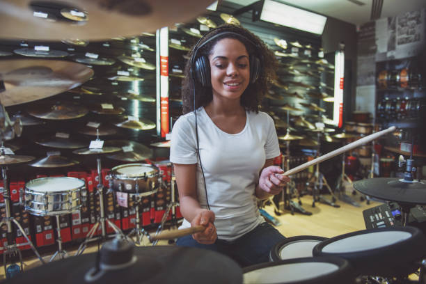 istock Woman playing electronic drums 1366261405
