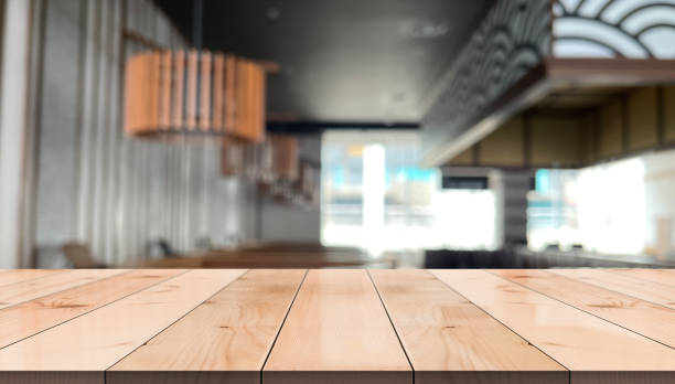 istock Empty wooden table top with lights bokeh on blur restaurant background. 1366263058
