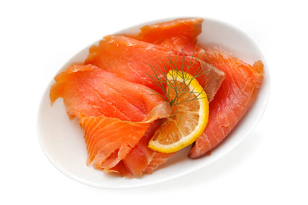 Smoked Salmon Smoked salmon in small white dish, garnished with lemon and dill.  Isolated on white. smoked salmon stock pictures, royalty-free photos & images