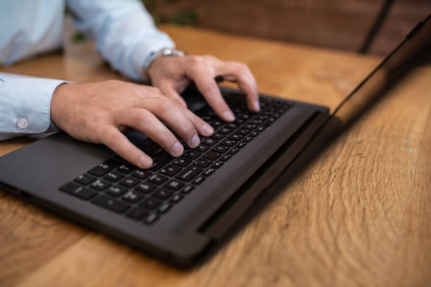 istock Hands and laptop. A young man using his laptop, working. Close-up. 1366268435