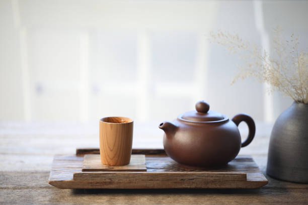 istock Pottery tea pot and bamboo tea cup on wooden tray 1366271914