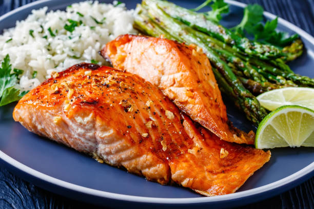 istock fried salmon fish fillet with rice and asparagus 1366272697
