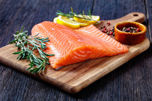 istock Fresh salmon fish fillet on wooden board 1366272710