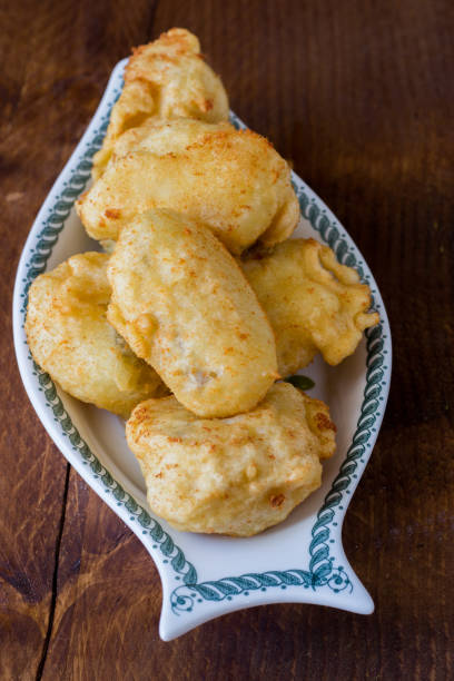 istock Fried cod served in serving dish on wooden background 1366274066