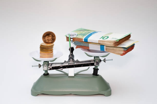 istock bitcoin coin and bundle of bills are on a scale 1366274829