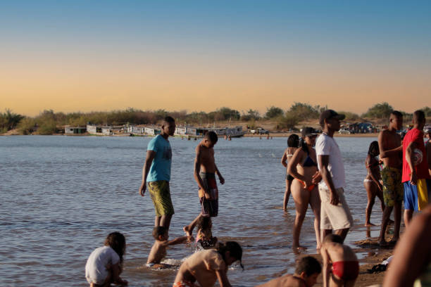 bom jesus da lapa, bahia, brazil - august 4, 2014: people are seen next to boats in the water of the Sao Francisco river in the city of Bom Jesus da Lapa.