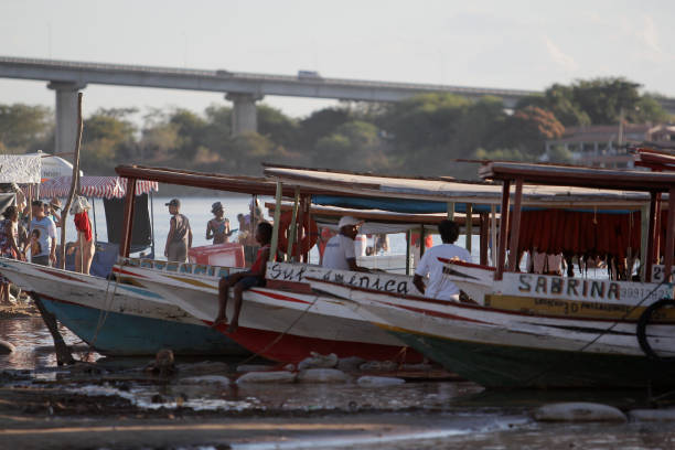 bom jesus da lapa, bahia, brazil - august 4, 2014: people are seen next to boats in the water of the Sao Francisco river in the city of Bom Jesus da Lapa.