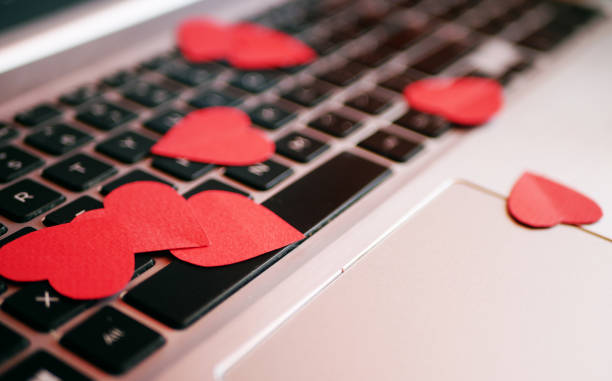 istock Heart-shaped confetti on laptop 1366275619