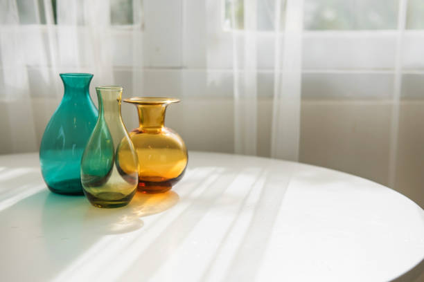 istock Colorful bottles on white table with sunlight 1366275720
