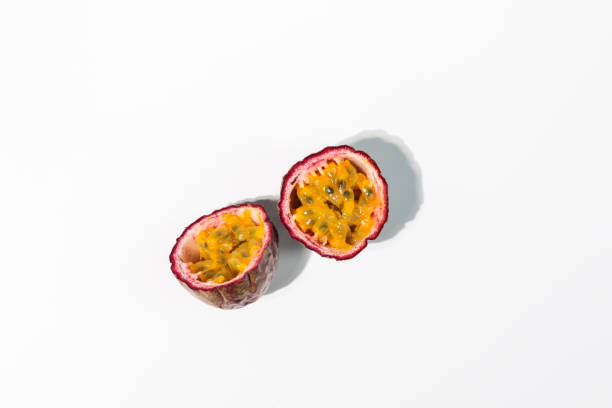 istock Fresh passion fruit halves on white background 1366276322