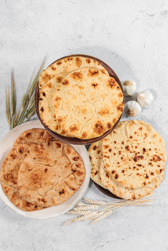 Variety of Indian naan bread chapatti with wheat whole grain and garlic