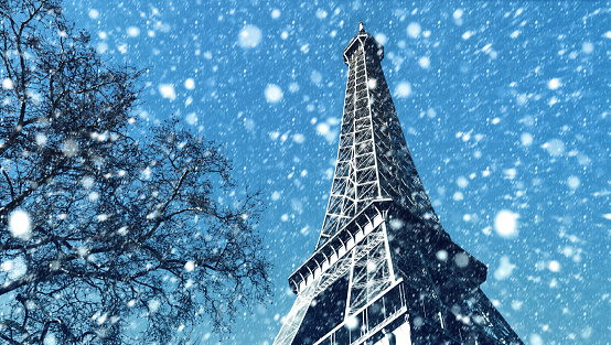 Eiffel Tower in Paris on a  winter day.  Snowfall in Paris