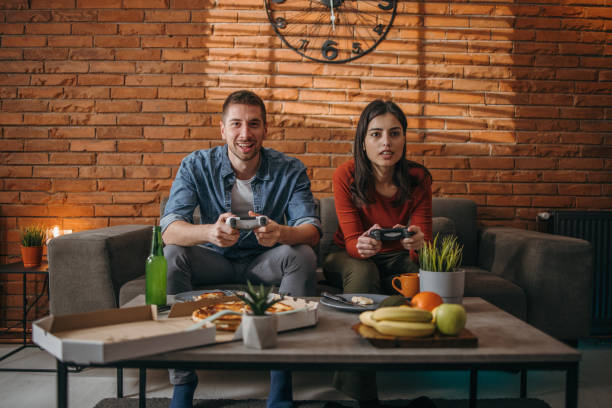 istock Couple of gamers 1366277744