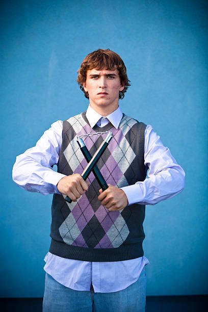 Young Male with Nunchucks. stock photo