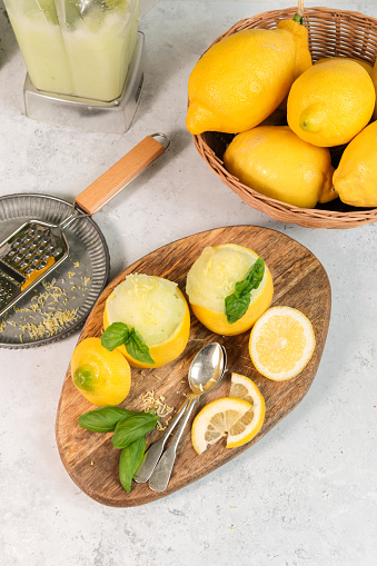 Frozen lemon sorbet with basil served in lemon halves