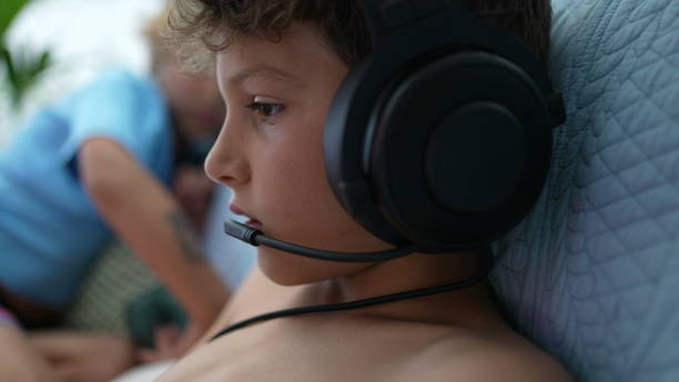 istock Little boy playing vide-game on portable console. Child plays game 1366279126