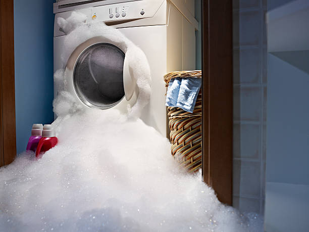 home disasters soap coming out from broken washing machine. washing machine photos stock pictures, royalty-free photos & images