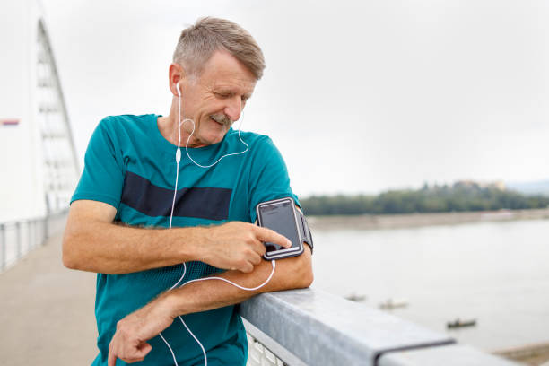 istock Senior runner man leaning on fence relaxing after exercise 1366282095