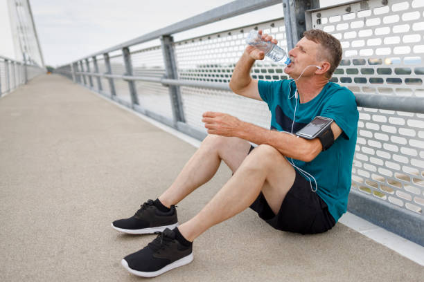 istock Senior fit man hydrating after a workout 1366282127