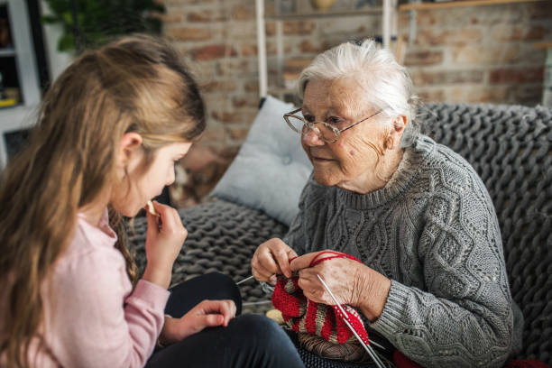 istock Granny teach granddaughter knitting with needles 1366283702