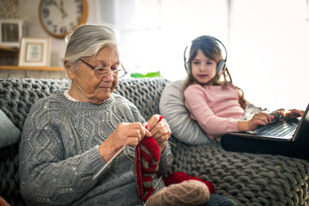 istock Granny teach granddaughter knitting with needles 1366283705