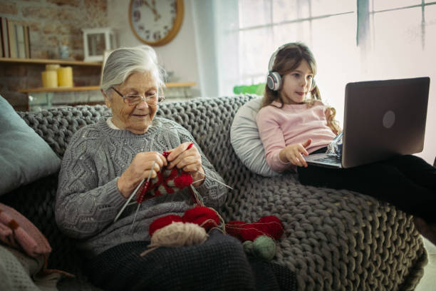 istock Granny teach granddaughter knitting with needles 1366283721