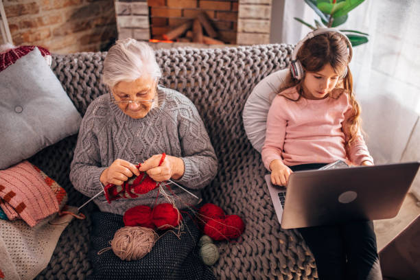 istock Granny teach granddaughter knitting with needles 1366283758