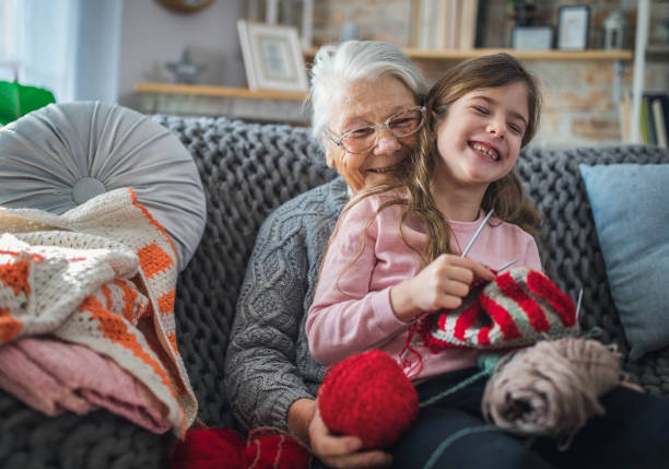 istock Granny teach granddaughter knitting with needles 1366283780