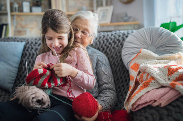 istock Granny teach granddaughter knitting with needles 1366283783
