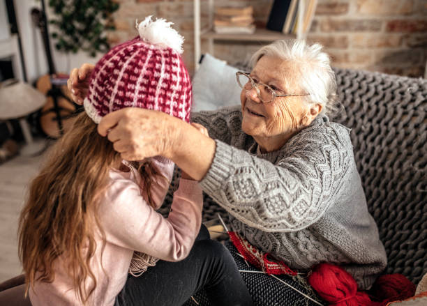 istock Granny teach granddaughter knitting with needles 1366283806