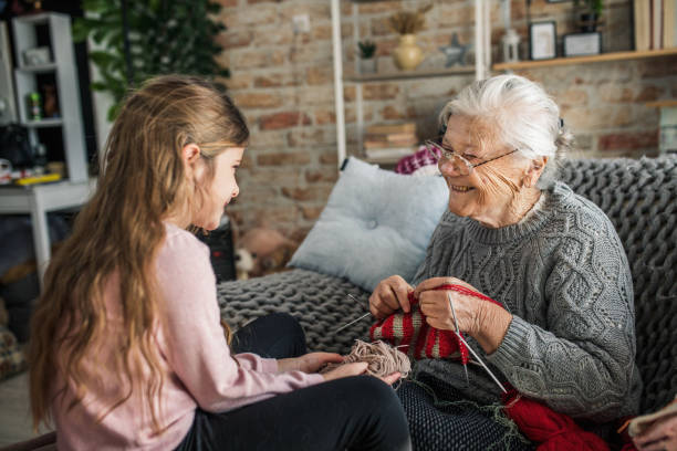 istock Granny teach granddaughter knitting with needles 1366283809