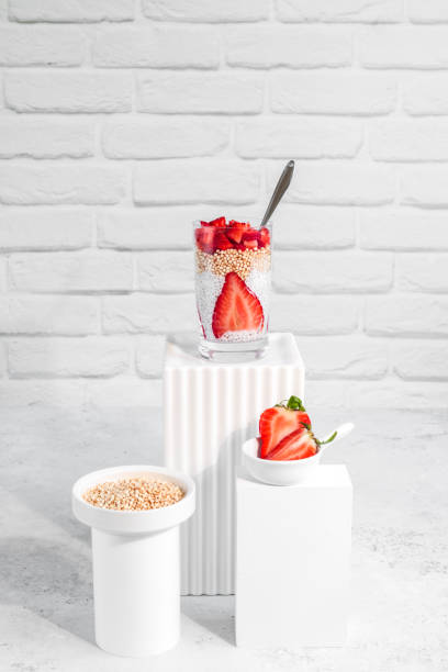 Healthy Vegan coconut chia pudding breakfast with puffed quinoa and fresh strawberries