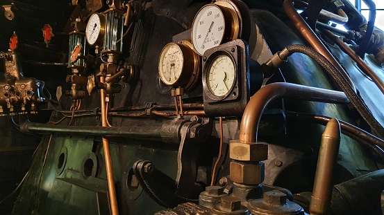 Close up of dials and pipes in steam locomotive