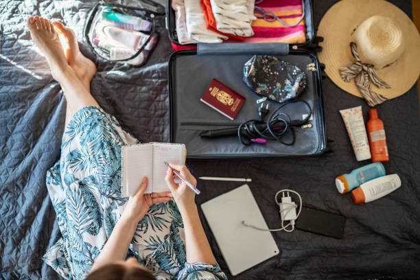 Young woman doing her last check to be sure if she have everything she needs for vacation stock photo