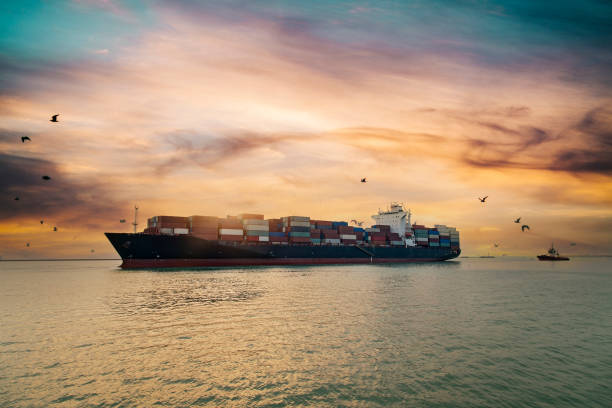 istock Aerial view of Cargo Ship approaching port with tugboat. 1366287689