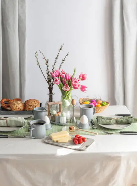 Sunday breakfast table setting with eggs, coffee, butter and bread in Germany