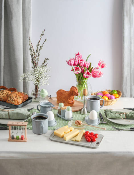 istock Easter Sunday brunch breakfast table setting with coffee, Easter lamb cake and tulips 1366287913