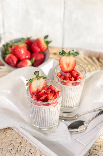 Strawberry coconut chia pudding dessert glasses with fresh fruit