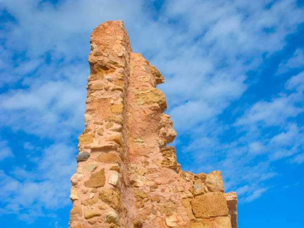 Greece, Crete. Part of ruins of the former Venetian port in Chania. Pointed ruins are isolated on blue sky.
