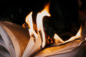 istock Open book is on fire, pages are engulfed in flames. Concept of censorship, prohibition of freedom information, 451 fahrenheit, old literature in paper format is no longer in demand. 1366289789