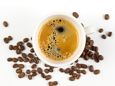 A cup of coffee and coffee beans on white background