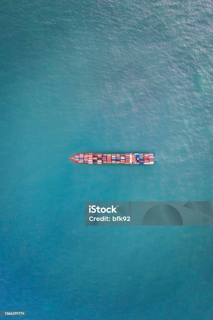 Cargo ship in the ocean. Aerial view of cargo container ship in transit. Container Ship Stock Photo