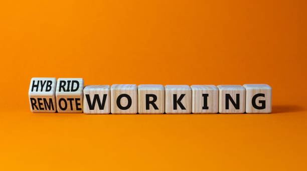 istock Hybrid or remote working symbol. Turned wooden cubes and changed words 'remote working' to 'hybrid working'. Beautiful orange background. Business, hybrid or remote working concept, copy space. 1366292686