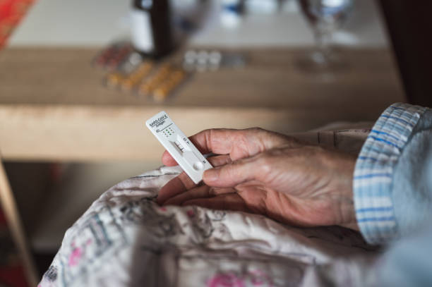 istock Covid-19 positiv test kit in old woman's hand 1366294495